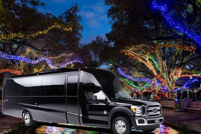 Deluxe party bus outside the illuminated trees at River Oaks
